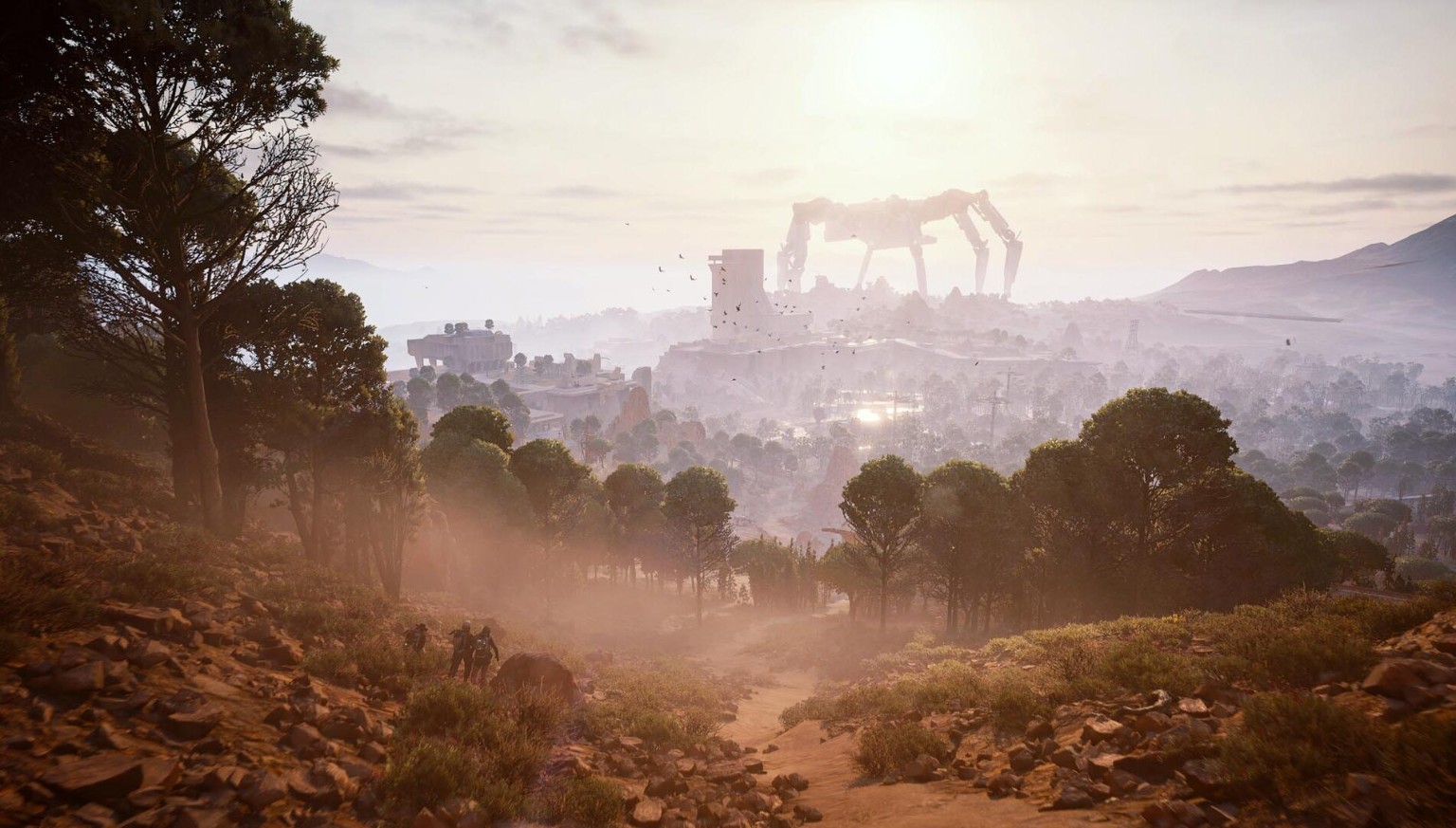 Wooded path overlooking ruined buildings and an enormous machine on the horizon