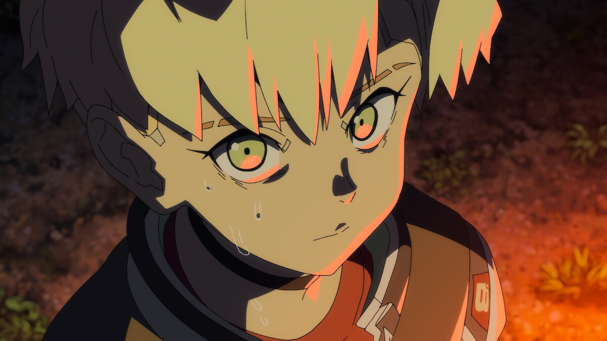 Close-up of a young character with gold eyes in warm orange lighting
