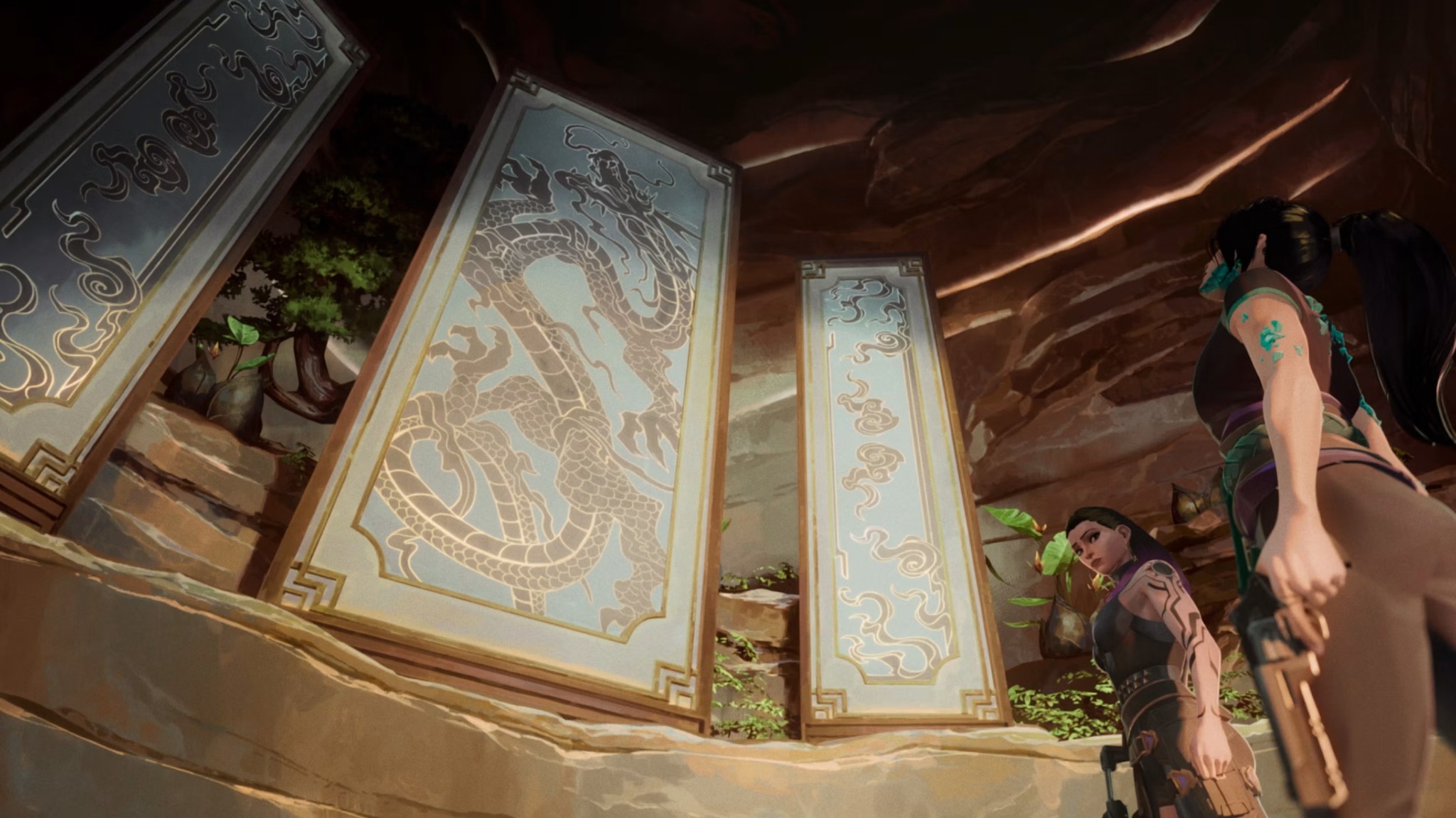 Decorated stone panels frame Sage and another figure inside the training facility.